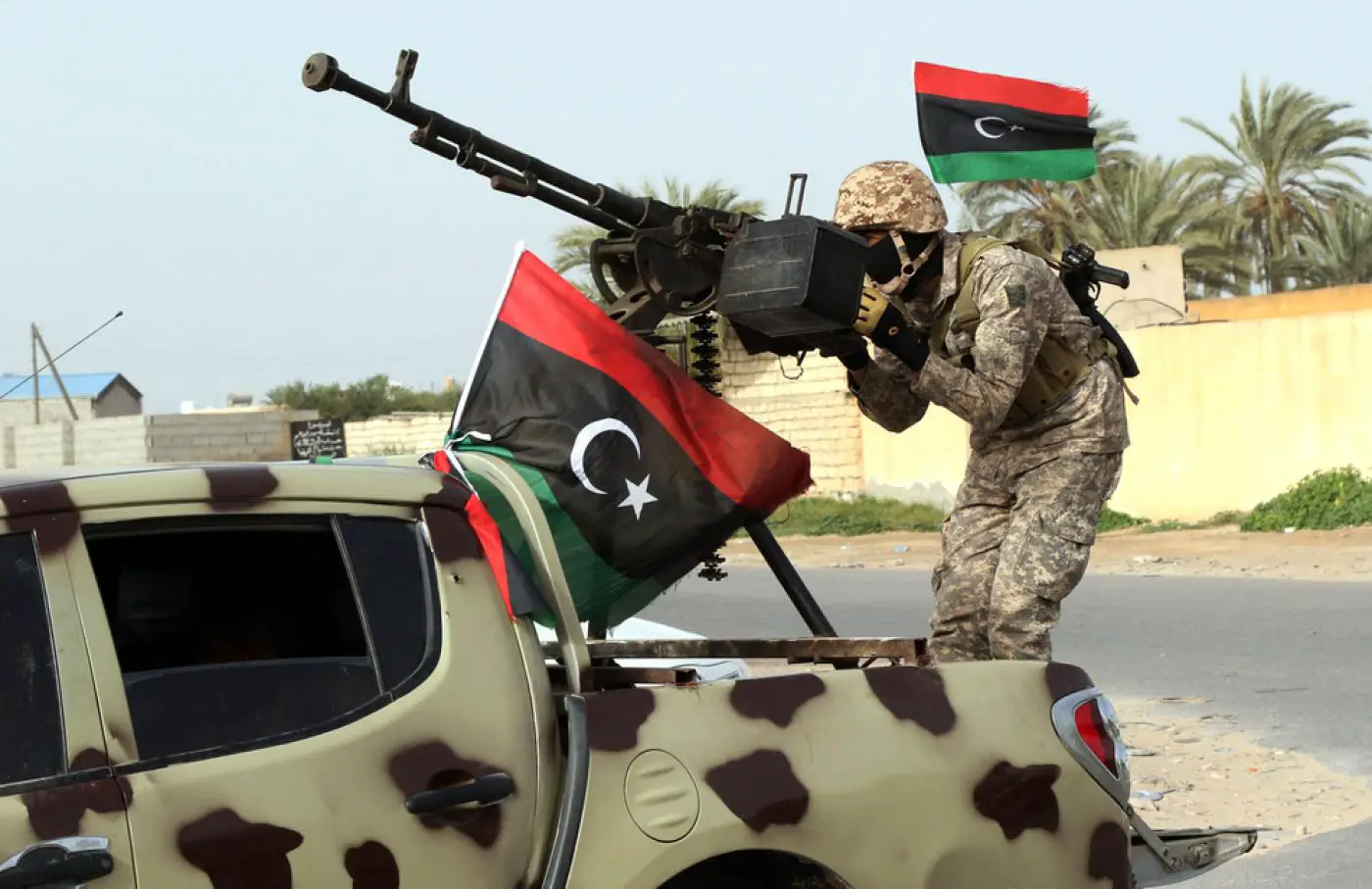 Libyan soldier standing on top of a car