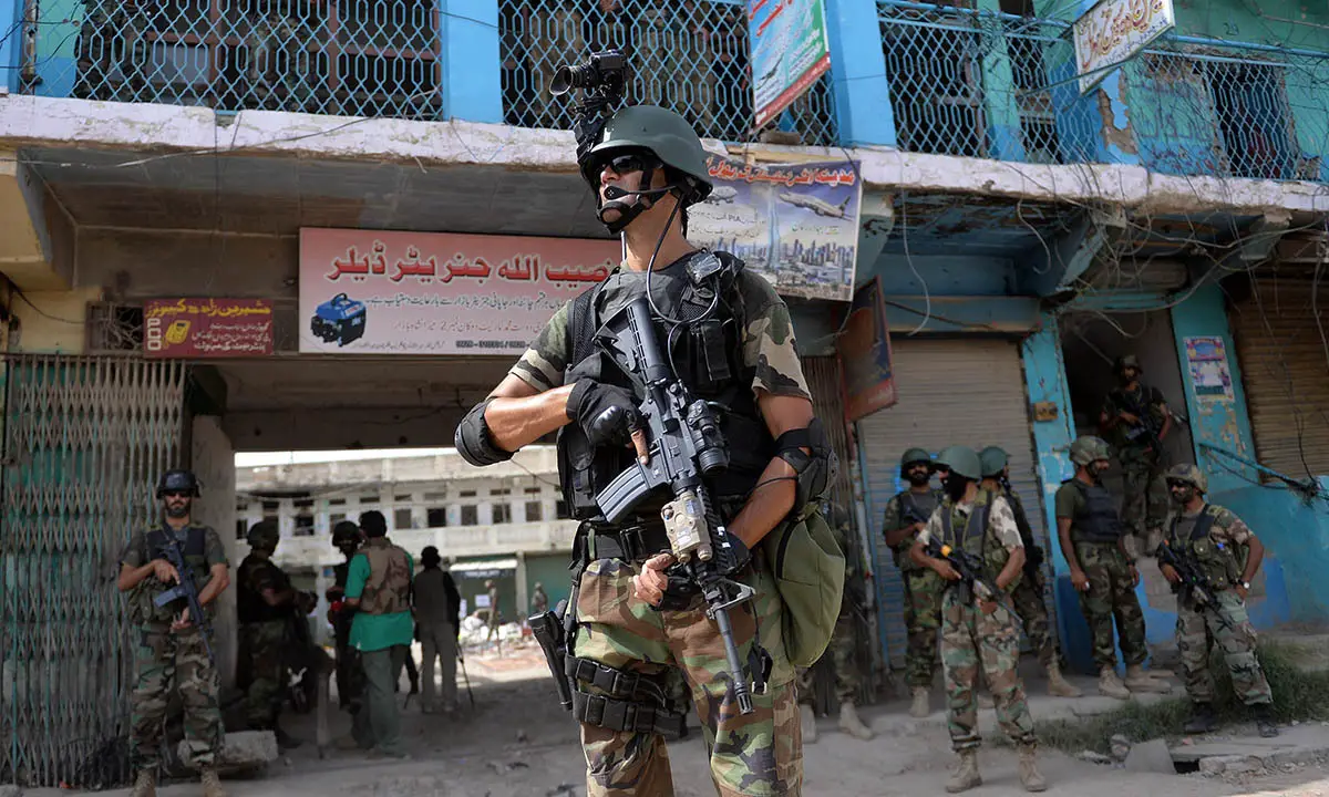 Pakistani soldiers patrol at an empty bazaar during a military operation against Taliban militants in North Waziristan
