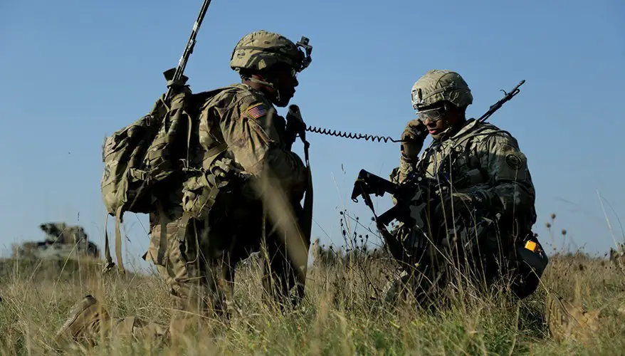 A U.S. Soldier assigned to 2d Cavalry Regiment (2CR) listens to radio communication during Dragoon Ready at the 7th Army Training Command's Grafenwoehr Training Area, Germany, Oct. 16, 2018.