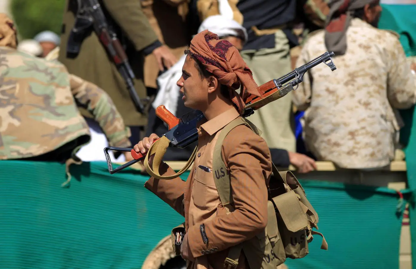 A fighter loyal to Yemen's Houthis attends the funeral of fellow combatants killed in battles with Saudi-backed government troops in Sanaa, February 2021