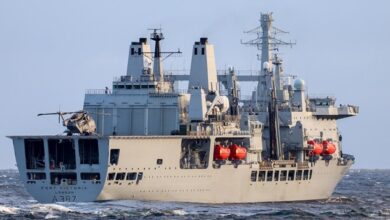 RFA Fort Victoria is seen sailing in calm waters. The ship is painted gray.