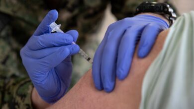Medic administering vaccine to soldier
