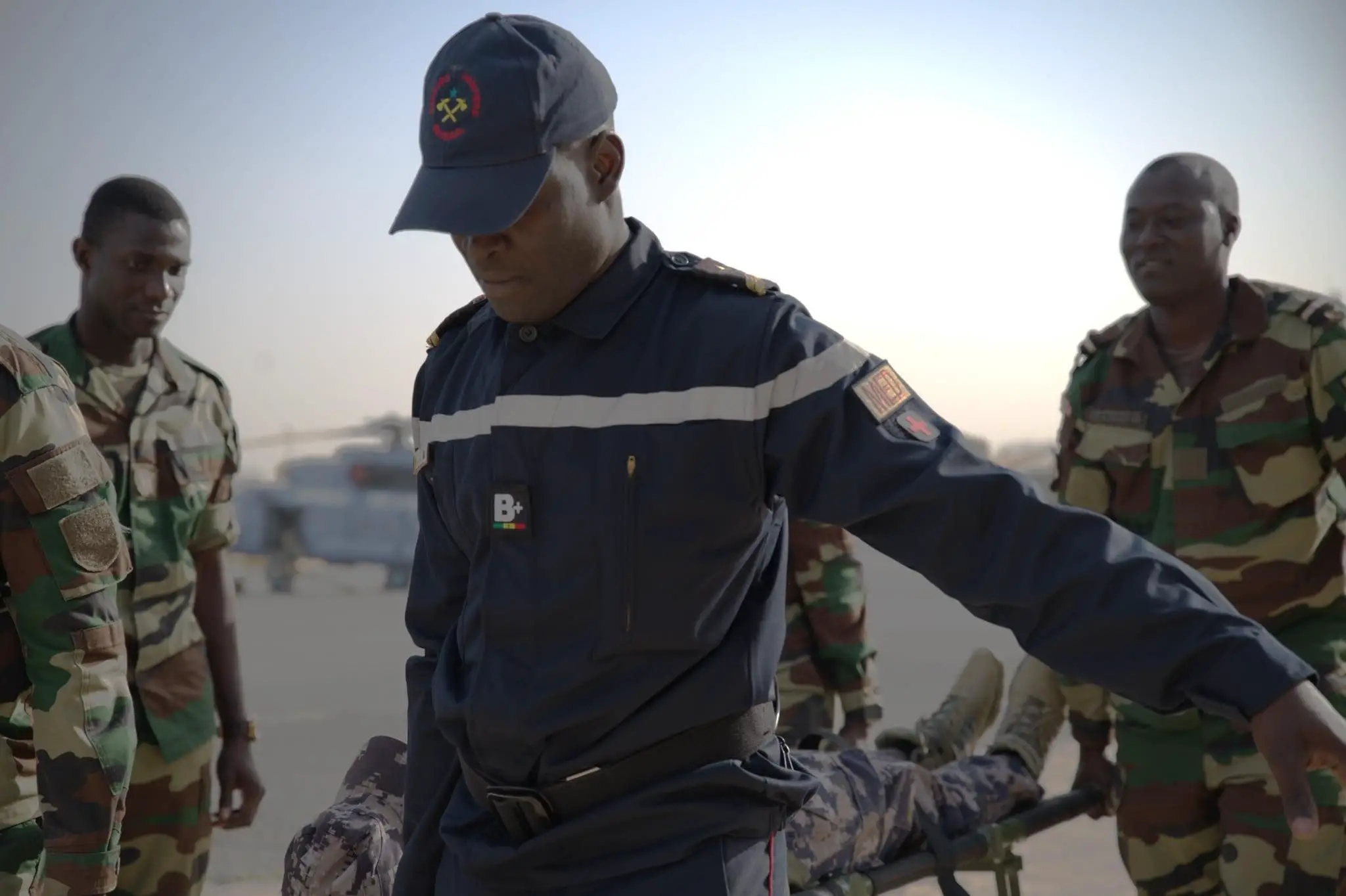 Senegal Air Force Medic carries a litter with a patient on it during an exercise scenario of Aeromedical Evacuation Team Phase V at Ouakam Air Base, Senegal, Jan. 24, 2024. The completion of Phase V of the AMET training signifies a remarkable journey for the Senegalese Air Force which has been actively involved in Aerial Patient Movement in collaboration with USAFE-AFAFRICA Surgeon General Office and Defense Institute for Military Operations since 2019. (U.S. Air Force photo by Dreshawn Murray)