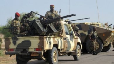 Armed Cameroon soldiers on a jeep