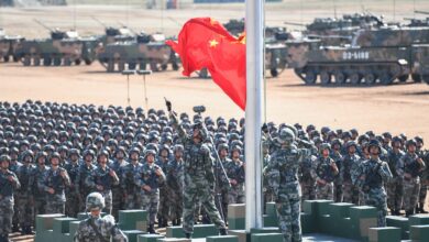 The Chinese flag is raised during a military parade at the Zhurihe training base