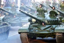 Croatian soldiers salute on top of armored vehicles during a parade in Zagreb