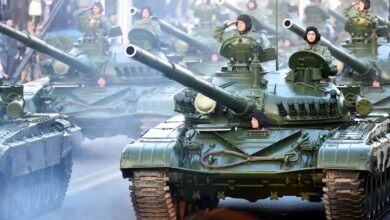 Croatian soldiers salute on top of armored vehicles during a parade in Zagreb
