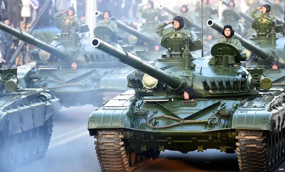 Croatian soldiers salute on top of armored vehicles during a parade in Zagreb