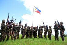 Philippine soldiers seen bannering the country's flag after killing almost 40 militants loyal to Islamic State groups