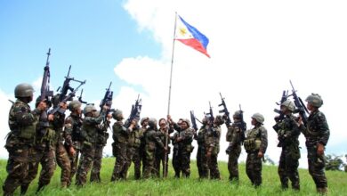 Philippine soldiers seen bannering the country's flag after killing almost 40 militants loyal to Islamic State groups