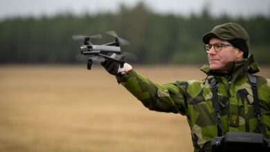 Personnel deploys Parrot drone by hand
