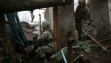 Ukrainian soldiers keep watch on the frontline with Russia-backed separatists