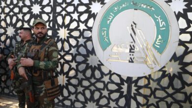 Members of Iraq's Hashed al-Shaabi stand guard at the entrance of their headquarters in Baghdad