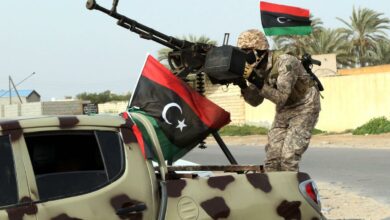 Libyan soldier standing on top of a car