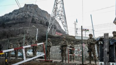 Azerbaijani servicemen stand guard at a checkpoint at the Lachin corridor, which links the disputed Nagorno-Karabakh region with Armenia