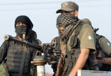Pakistani soldiers take position outside the Pakistan Air Force base after an attack by militants in Peshawar
