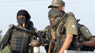 Pakistani soldiers take position outside the Pakistan Air Force base after an attack by militants in Peshawar