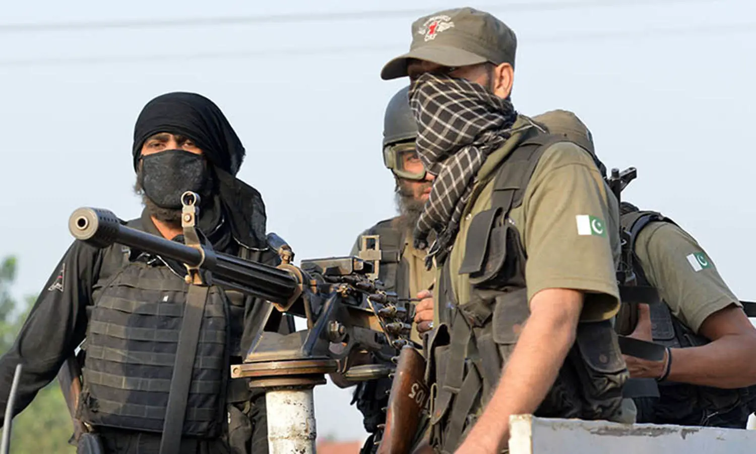 Pakistani soldiers take position outside the Pakistan Air Force base after an attack by militants in Peshawar