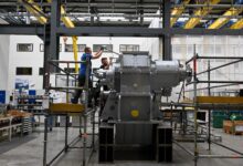 Employees work at a ship gear at a Renk facility in Augsburg, Germany
