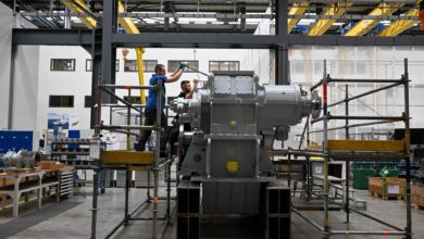 Employees work at a ship gear at a Renk facility in Augsburg, Germany