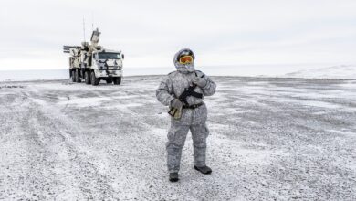 A soldier holds a machine gun as he patrols the Russian northern military base on Kotelny island, beyond the Artic circle on April 3, 2019.