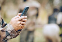 Soldier holding phone in his hand