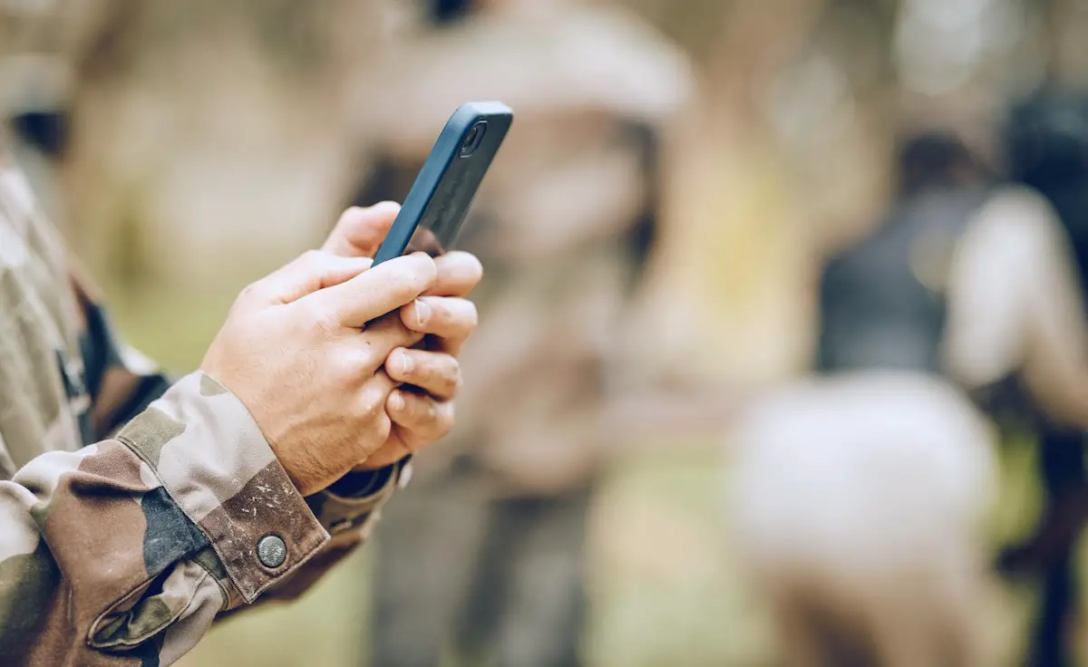 Soldier holding phone in his hand