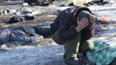 Man cries next to the body of his wife killed as a result of a missile strike in Donetsk on January 21, 2024