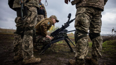 Ukrainian soldiers check their weapons at a position on the front line in eastern Ukraine's Donetsk region on Oct. 24, amid the Russian invasion of Ukraine