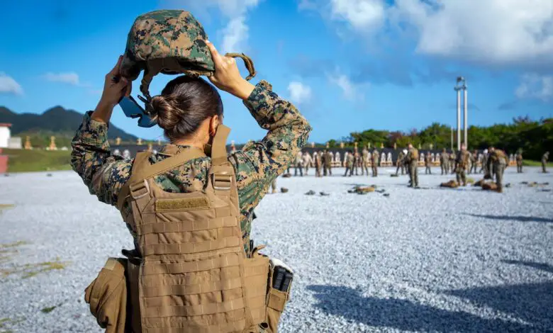 US Marine Corps Sergeant places on a kevlar.
