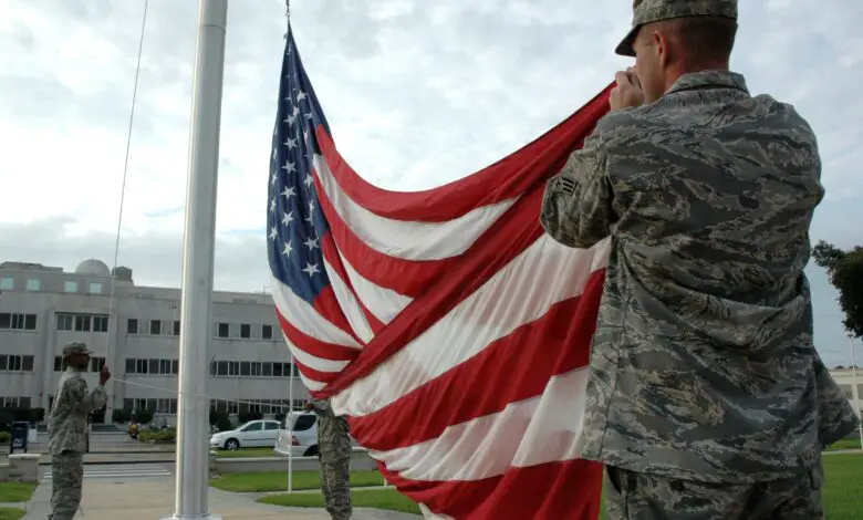 American soldier raising US flag