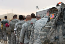 US army soldiers queue to board a plane to begin their journey home out of Iraq from the al-Asad Air Base west the capital Baghdad, November 1, 2011.