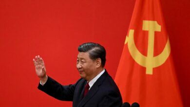 China's President Xi Jinping waves after introducing the members of the Chinese Communist Party's new Politburo Standing Committee, 2022