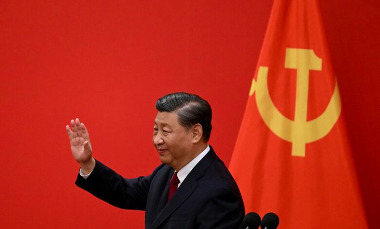 China's President Xi Jinping waves after introducing the members of the Chinese Communist Party's new Politburo Standing Committee, 2022