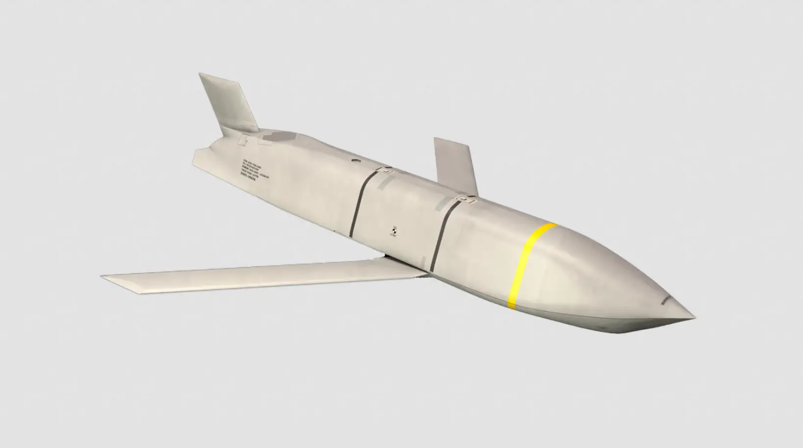 A Lockheed Martin Joint Air-to-Surface Standoff Missile is seen front and center of the image. The background is plain white. The missile has fixed wings and a tail, painted dirty white with two black stripes and one yellow stripe painted on its body.