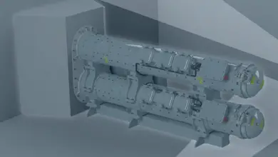 An artist's 3d rendering of a SEA Torpedo Launch System. The gray equipment appears to be two metallic containers shaped like long canisters. They appear to be covered in rivets and small mechanisms.
