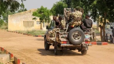 Nigerian Army soldiers are seen driving on a military vehicle in Ngamdu, Nigeria